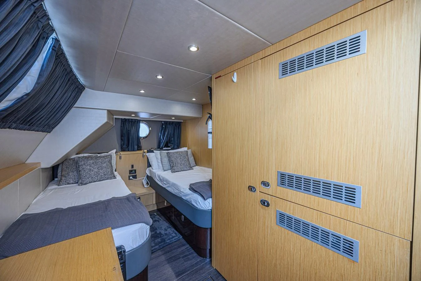 The guest stateroom offers comfortable twin beds with modern amenities and ample storage space. aboard DIRTY DAWG Yacht for Sale