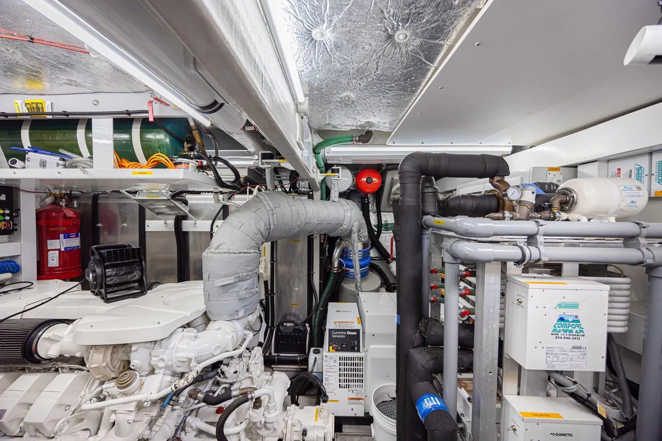 The image showcases the yacht's well-organized engine room with various mechanical and electrical components. aboard DIRTY DAWG Yacht for Sale