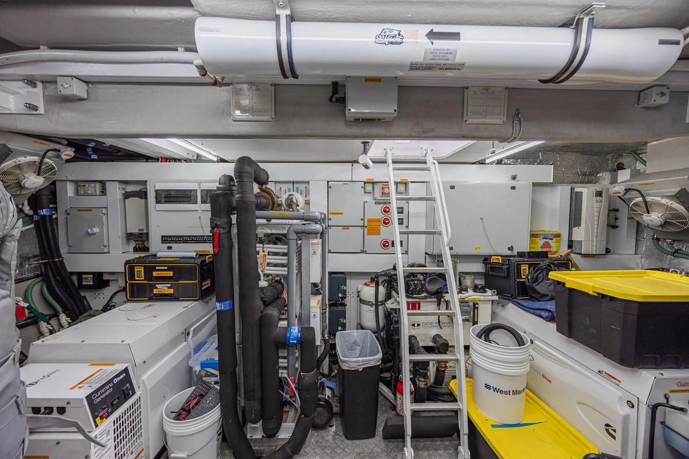 The image showcases the well-organized engine room of the yacht, equipped with various machinery and tools. aboard DIRTY DAWG Yacht for Sale