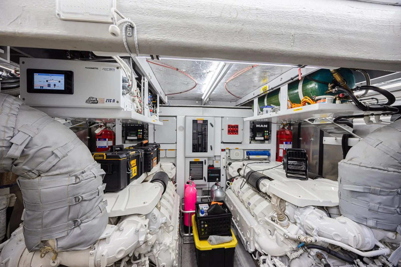 The image showcases the well-maintained engine room of the yacht, featuring advanced machinery and organized storage. aboard DIRTY DAWG Yacht for Sale
