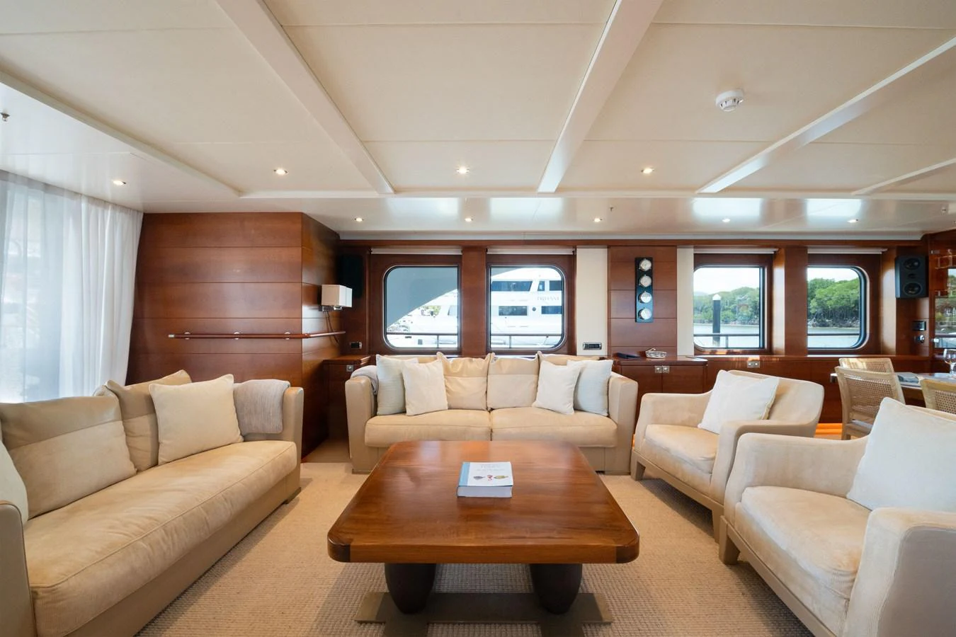 The salon features plush seating and elegant wooden accents, creating a cozy and inviting atmosphere. aboard BELUGA Yacht for Sale