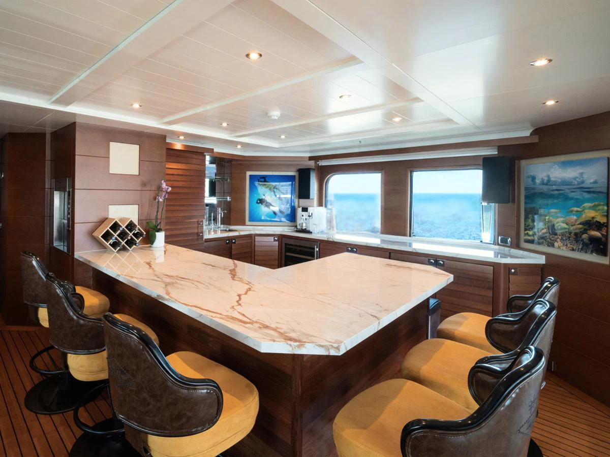 The galley features a luxurious marble countertop and comfortable seating, perfect for entertaining guests. aboard BELUGA Yacht for Sale