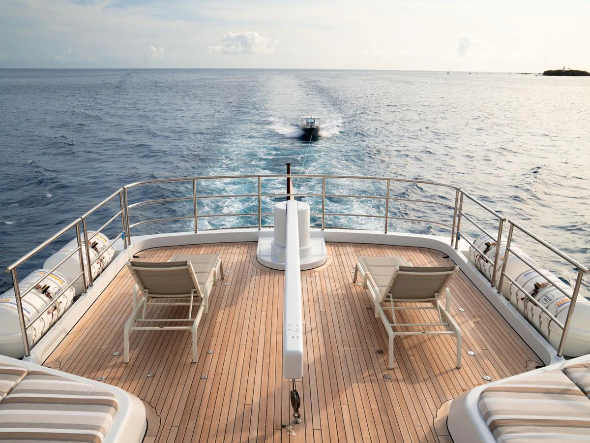 The aft deck offers a serene view of the open sea with comfortable lounging chairs on a spacious teak deck. aboard BELUGA Yacht for Sale