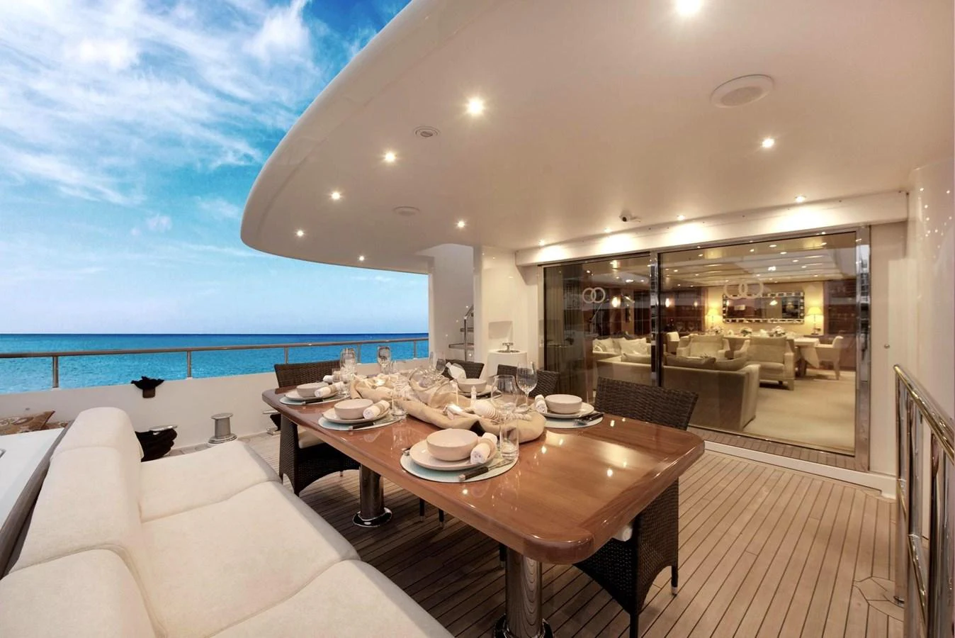 The aft deck features an elegant dining area with a stunning ocean view. aboard BELUGA Yacht for Sale