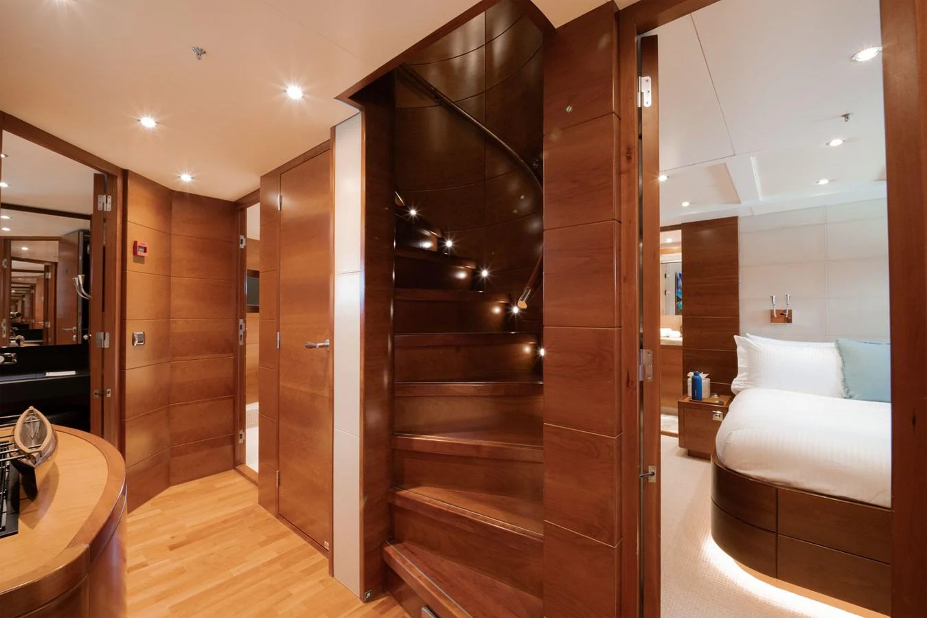 The yacht's elegant interior features a beautifully crafted wooden staircase leading to the upper deck. aboard BELUGA Yacht for Sale
