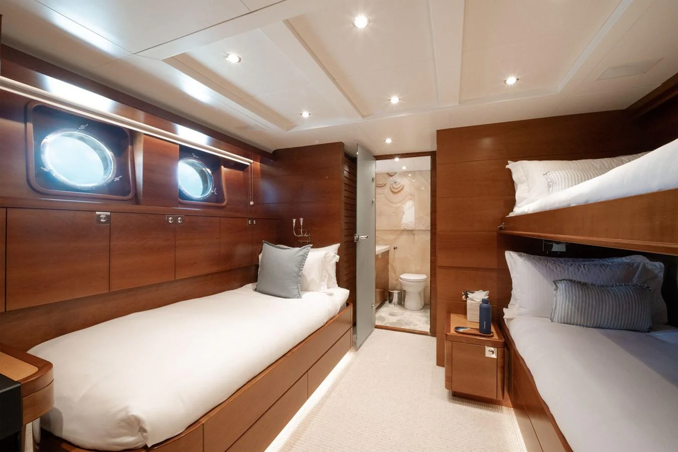 The guest stateroom features twin beds and a private en-suite bathroom, offering a cozy and comfortable retreat. aboard BELUGA Yacht for Sale