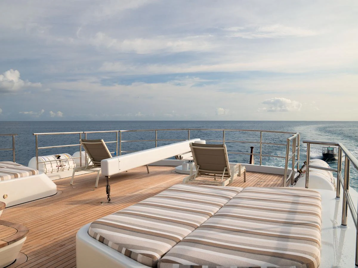 The sundeck offers a serene space with comfortable loungers and a stunning ocean view. aboard BELUGA Yacht for Sale