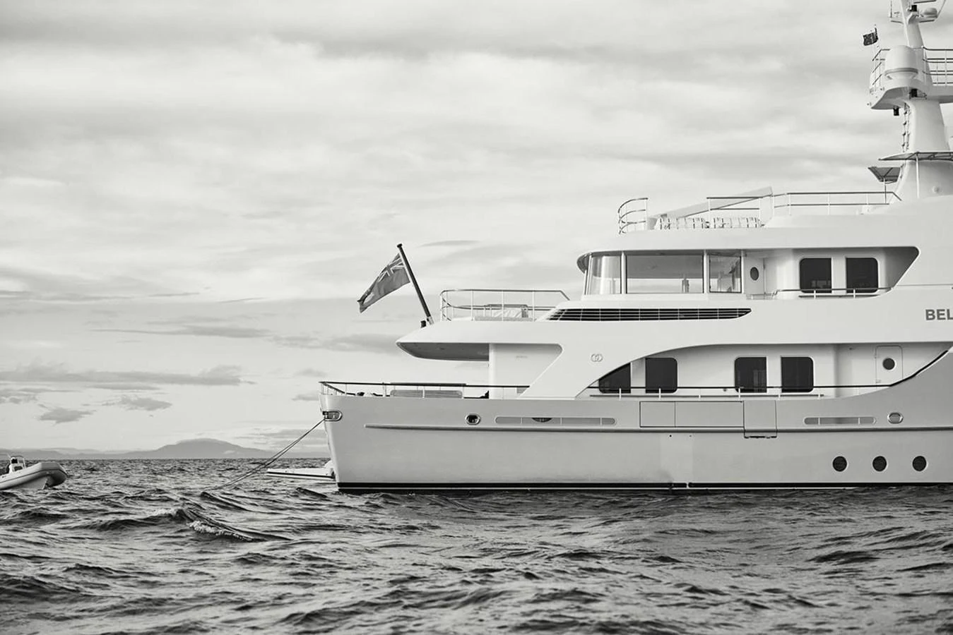 A luxurious yacht is anchored on calm waters, showcasing its elegant design and spacious decks. aboard BELUGA Yacht for Sale