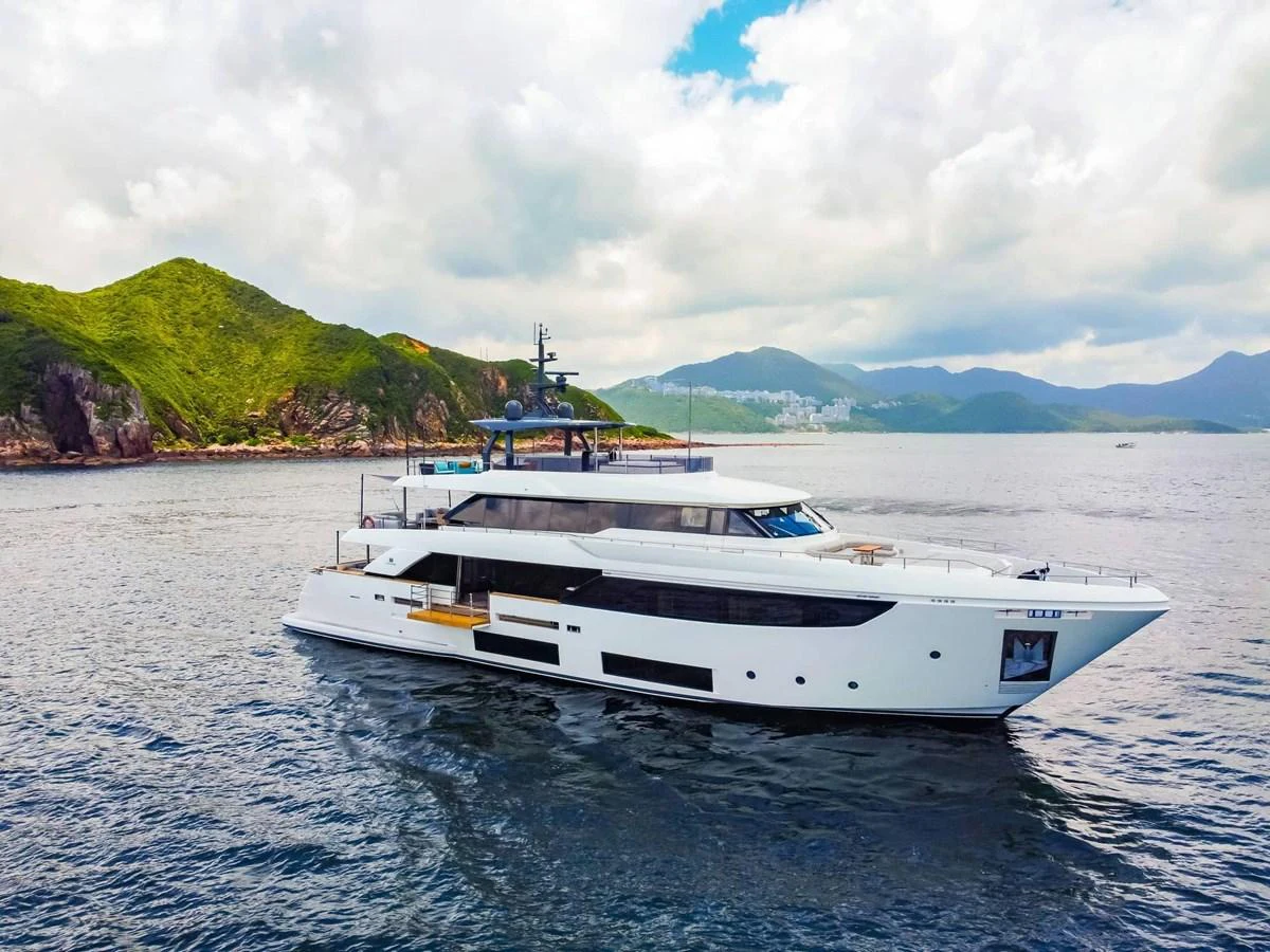 A sleek and modern yacht cruising in a picturesque coastal setting. aboard CUSTOM LINE NAVETTA 33 Yacht for Sale