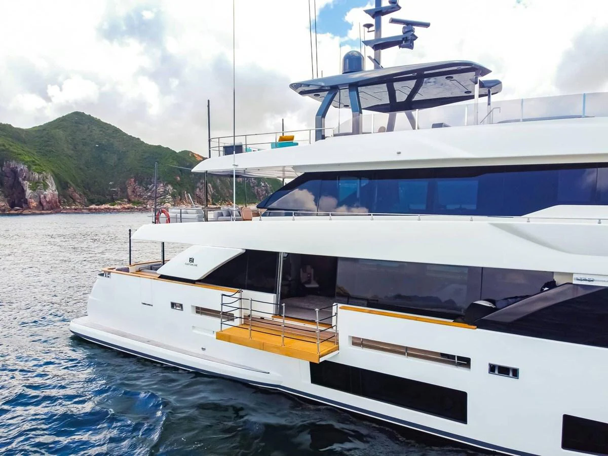 A sleek and modern yacht cruising along a scenic coastline, showcasing its elegant design and spacious decks. aboard CUSTOM LINE NAVETTA 33 Yacht for Sale