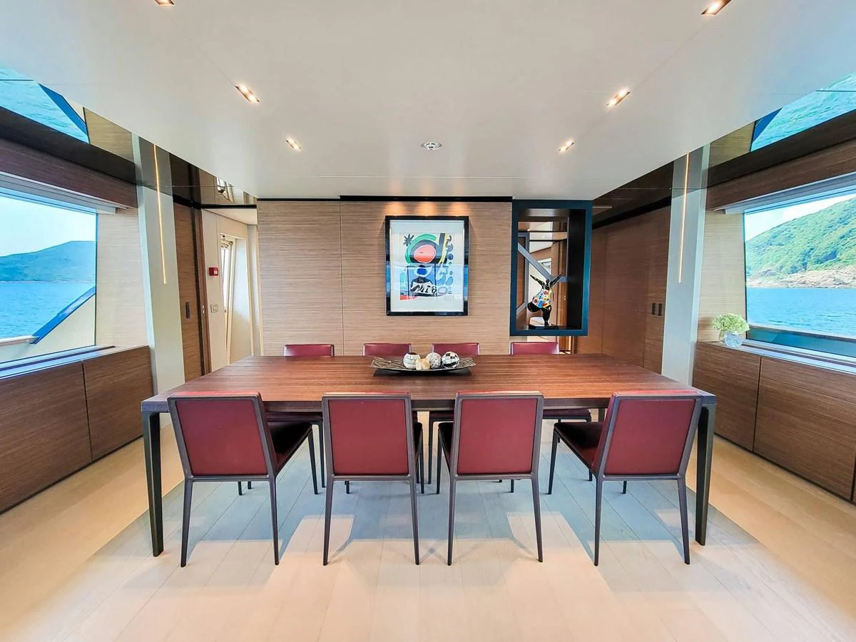 The yacht's dining area features a sleek table with comfortable seating and panoramic views. aboard CUSTOM LINE NAVETTA 33 Yacht for Sale