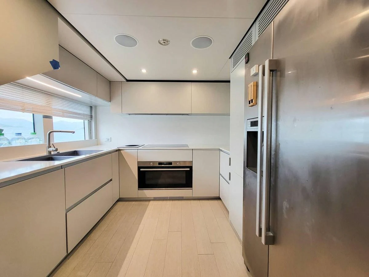 The modern galley features sleek cabinetry, high-end appliances, and ample counter space. aboard CUSTOM LINE NAVETTA 33 Yacht for Sale