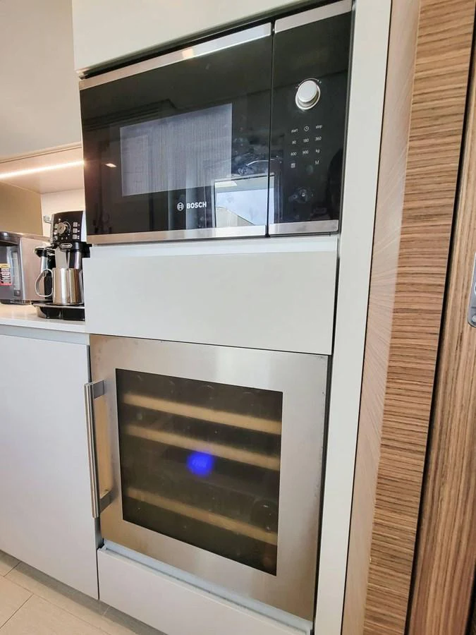 The galley features modern appliances including a microwave and a wine cooler. aboard CUSTOM LINE NAVETTA 33 Yacht for Sale