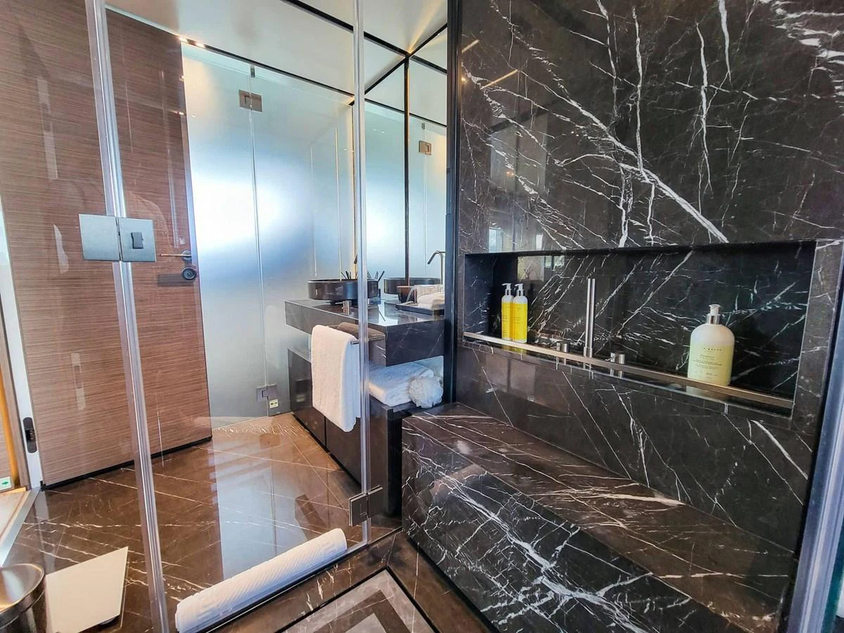 The yacht's bathroom features luxurious black marble finishes and modern fixtures. aboard CUSTOM LINE NAVETTA 33 Yacht for Sale