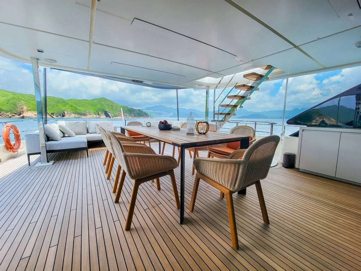 The aft deck features a spacious seating and dining area with stunning views of the surrounding waters. aboard CUSTOM LINE NAVETTA 33 Yacht for Sale