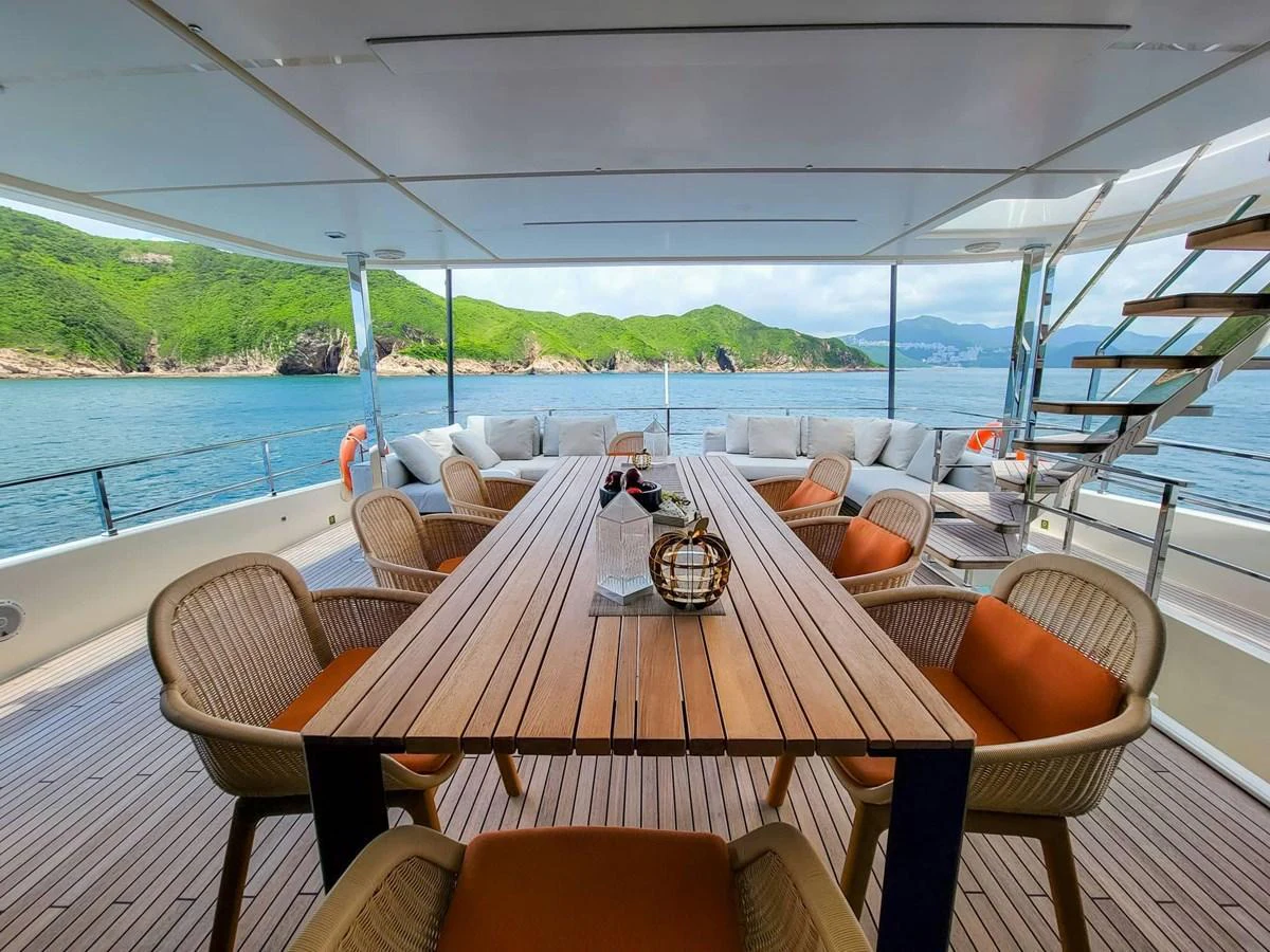 The aft deck features a spacious dining area with a stunning view of the surrounding waters. aboard CUSTOM LINE NAVETTA 33 Yacht for Sale