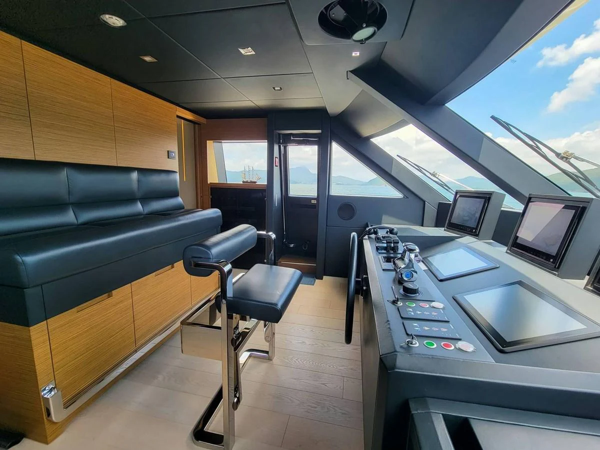 The helm station features modern navigation equipment and luxurious seating with a panoramic view. aboard CUSTOM LINE NAVETTA 33 Yacht for Sale