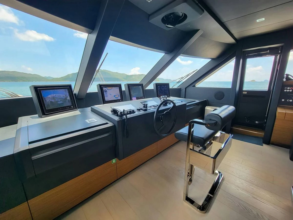 The helm station offers a modern and sleek design with advanced navigation equipment and panoramic views. aboard CUSTOM LINE NAVETTA 33 Yacht for Sale