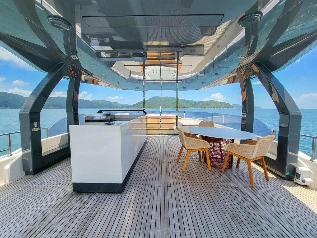 The flybridge offers a spacious and elegant area for dining and relaxation with stunning sea views. aboard CUSTOM LINE NAVETTA 33 Yacht for Sale
