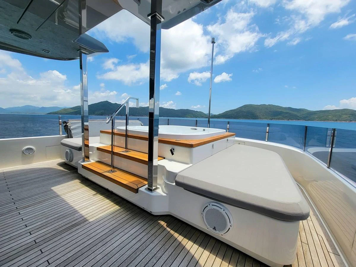 The sundeck features a luxurious hot tub with surrounding sun pads and stunning ocean views. aboard CUSTOM LINE NAVETTA 33 Yacht for Sale