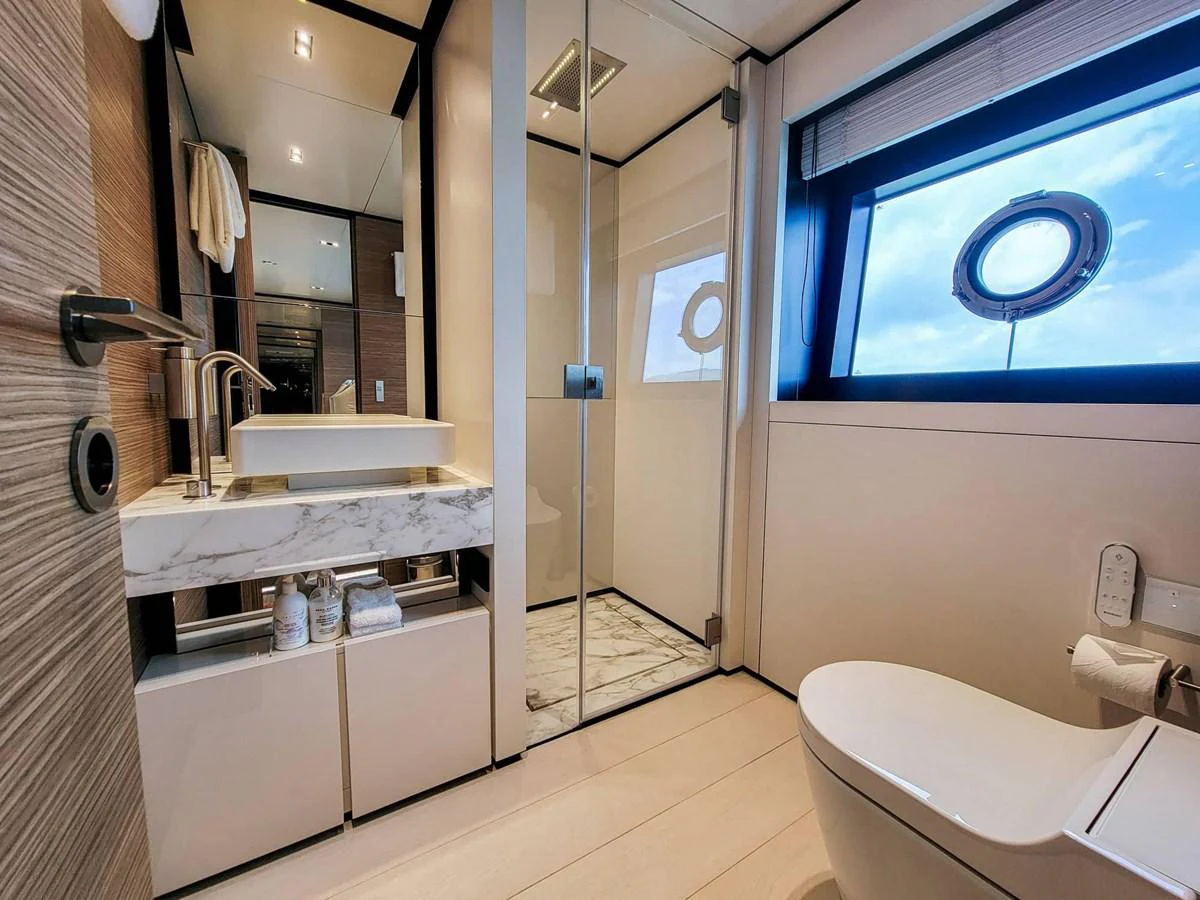 The yacht's bathroom features modern fixtures and a large window for natural light. aboard CUSTOM LINE NAVETTA 33 Yacht for Sale