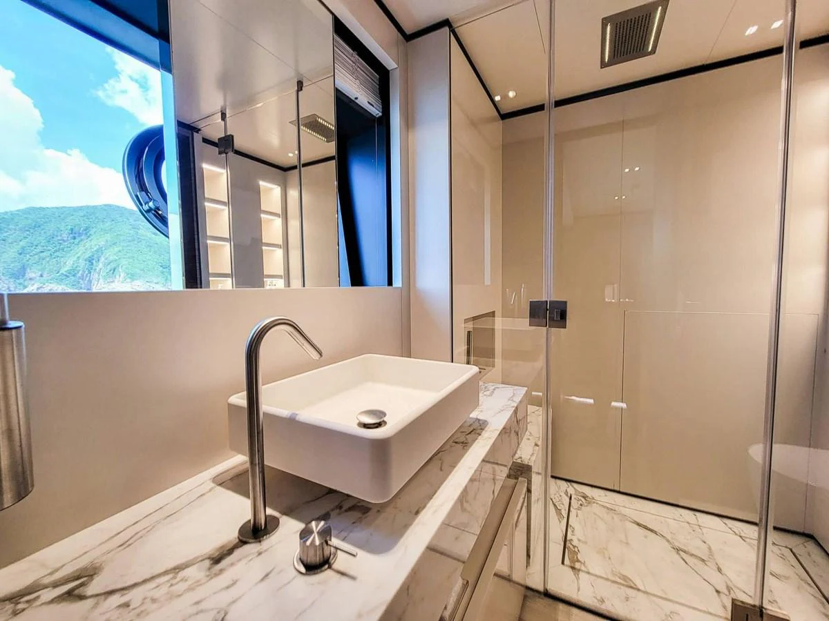 This luxurious yacht bathroom features a sleek, modern design with high-end fixtures and a scenic view. aboard CUSTOM LINE NAVETTA 33 Yacht for Sale