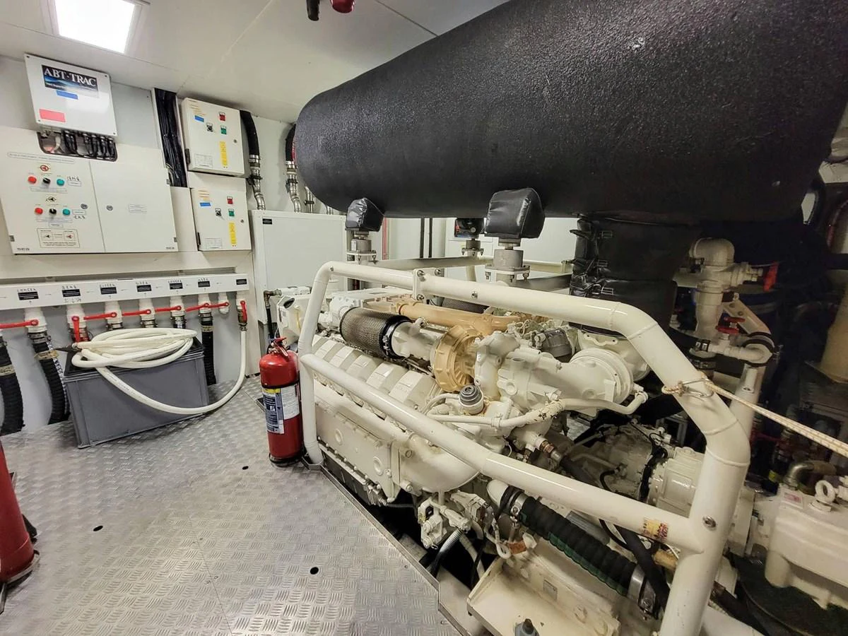 The image showcases the yacht's well-maintained engine room with visible machinery and control panels. aboard CUSTOM LINE NAVETTA 33 Yacht for Sale