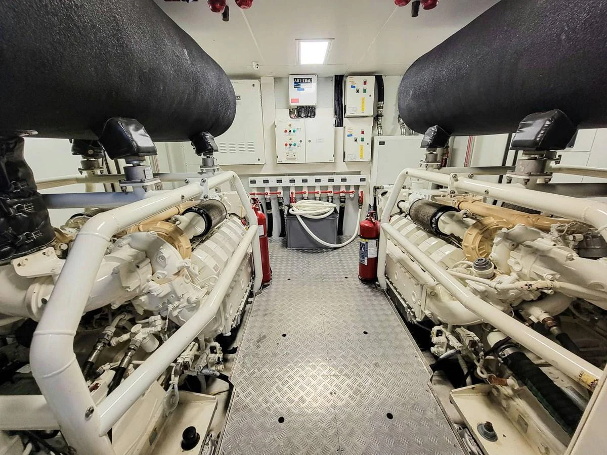 The image showcases the well-maintained engine room of the yacht, featuring dual engines and control panels. aboard CUSTOM LINE NAVETTA 33 Yacht for Sale