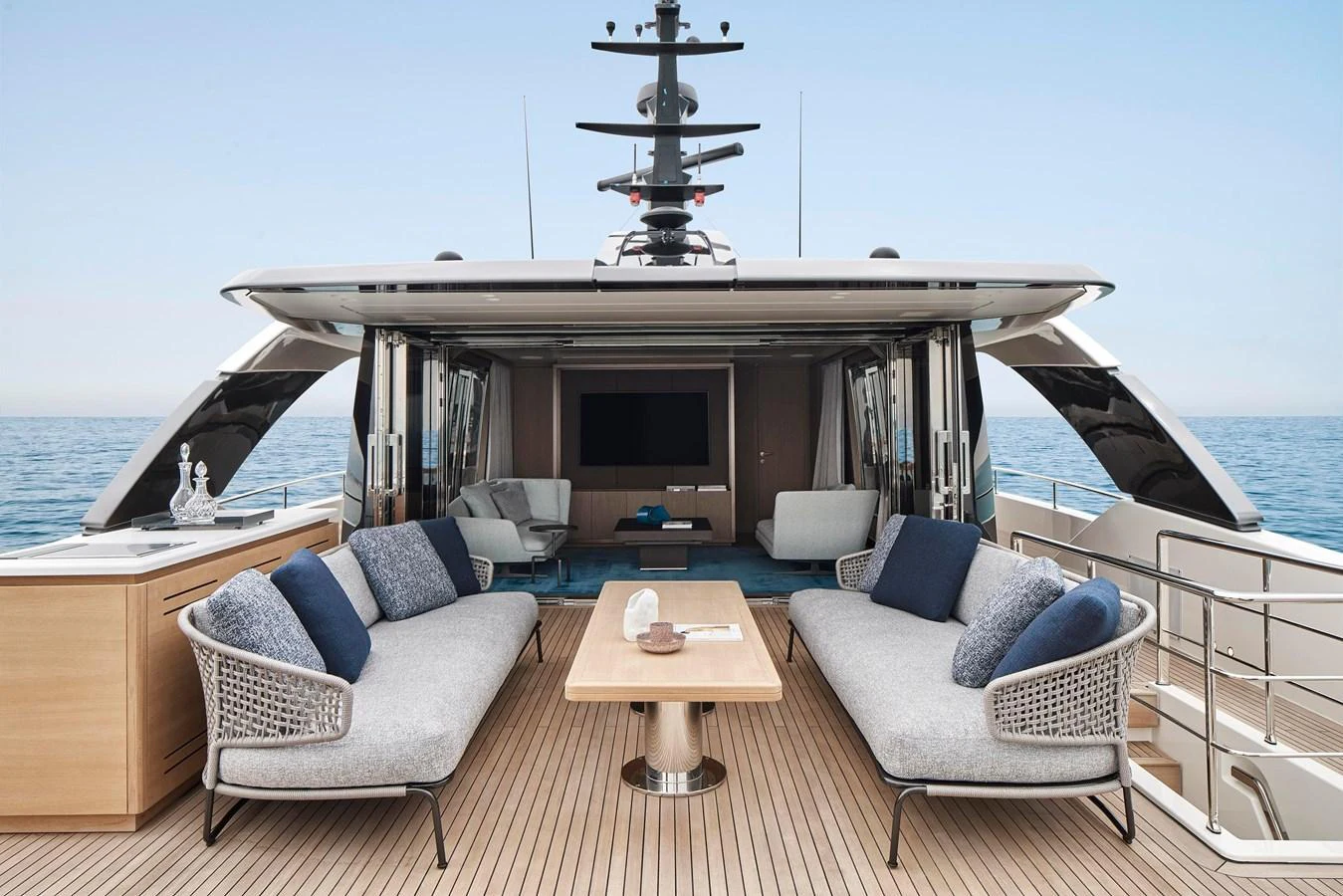 The yacht's aft deck features a luxurious outdoor seating area with a view of the sea. aboard SANLORENZO SD96 Yacht for Sale