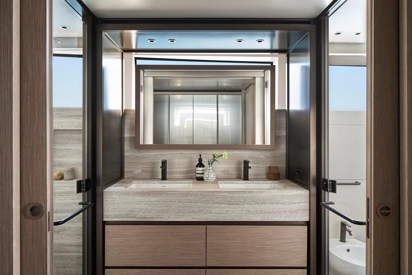A luxurious yacht bathroom featuring a double sink vanity and modern fixtures. aboard SANLORENZO SD96 Yacht for Sale
