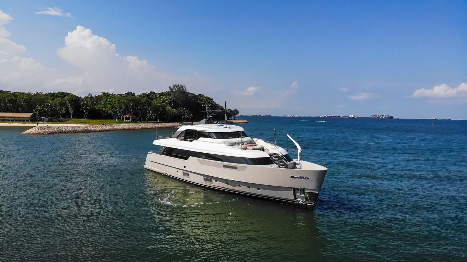 A sleek yacht glides gracefully on calm waters under a clear blue sky. aboard SANLORENZO SD96 Yacht for Sale
