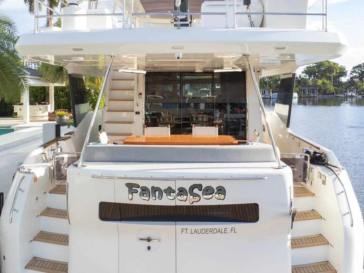 The aft deck of this yacht offers a welcoming space with a view of the serene waters. aboard FANTASEA Yacht for Sale
