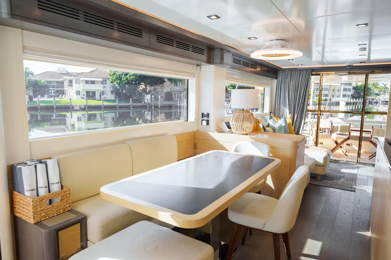 The yacht's salon features a spacious dining area with large windows offering scenic views. aboard FANTASEA Yacht for Sale