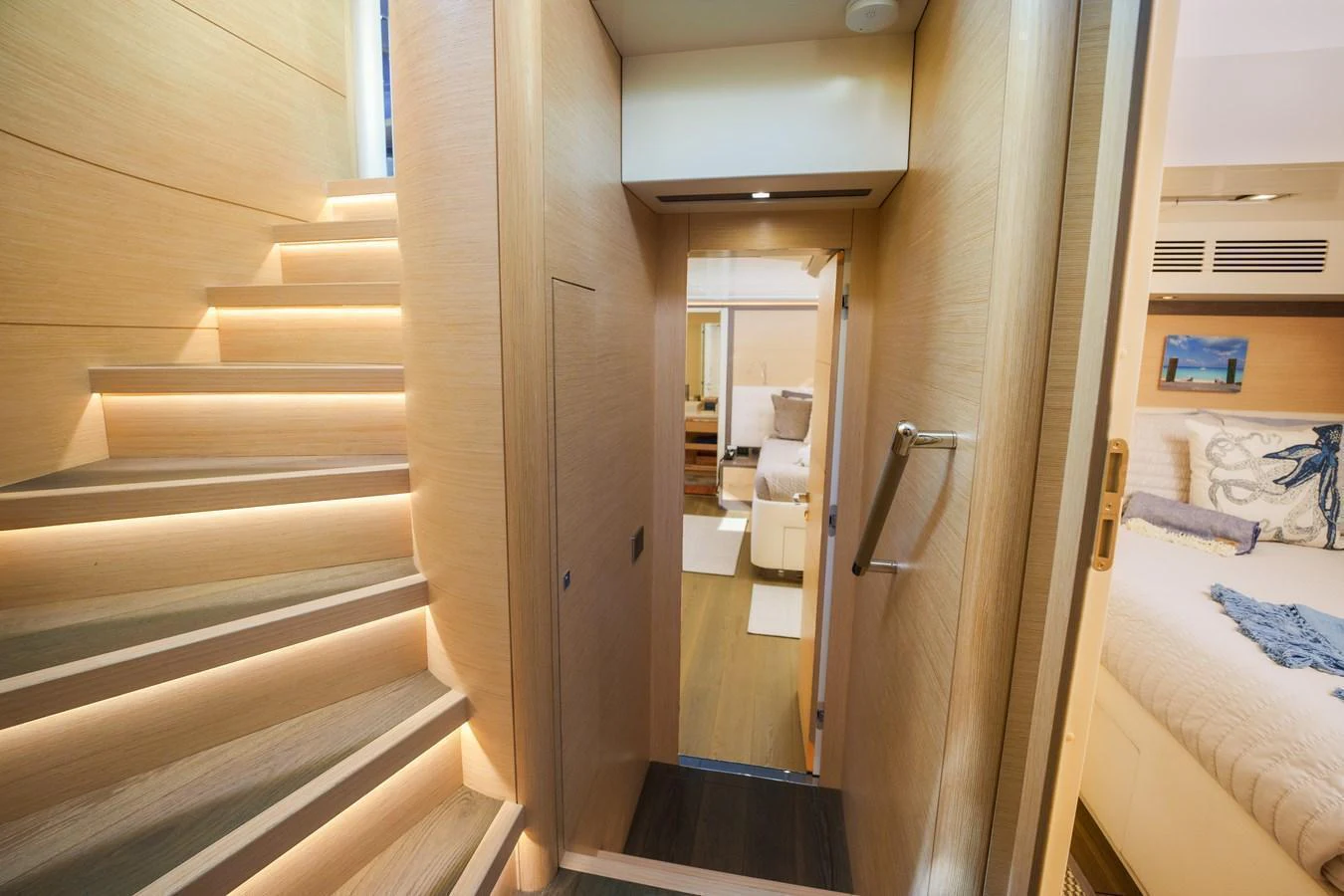 A beautifully lit staircase leads to a cozy and inviting interior space. aboard FANTASEA Yacht for Sale