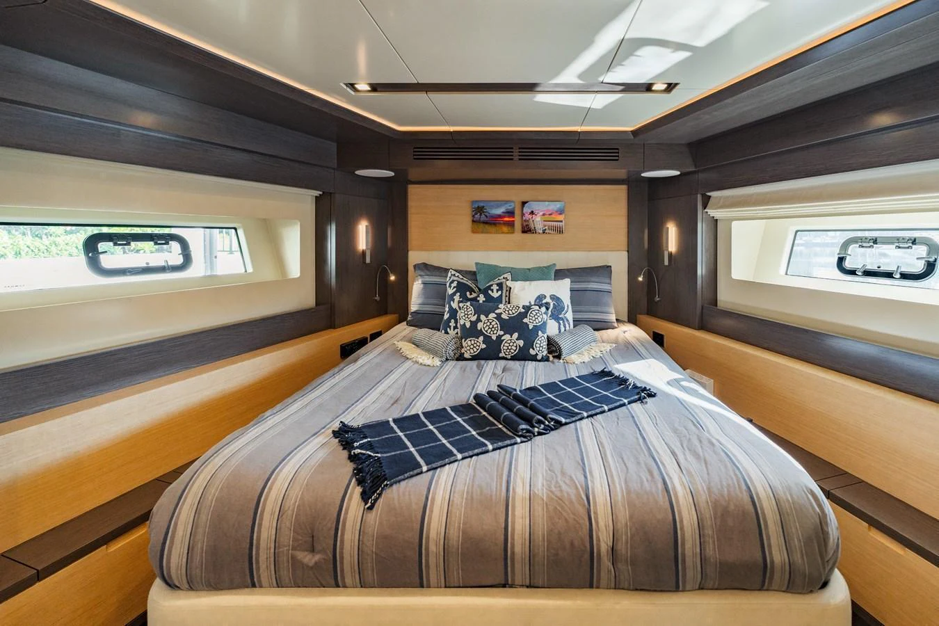 A cozy stateroom with a large bed and modern decor. aboard FANTASEA Yacht for Sale