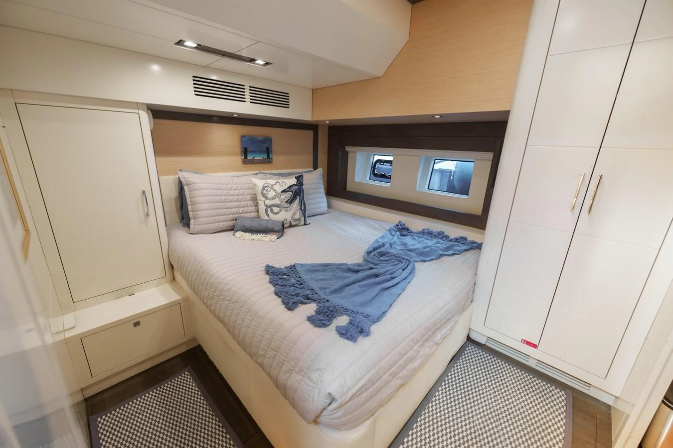 A cozy stateroom featuring a comfortable bed with elegant bedding and ample storage space. aboard FANTASEA Yacht for Sale