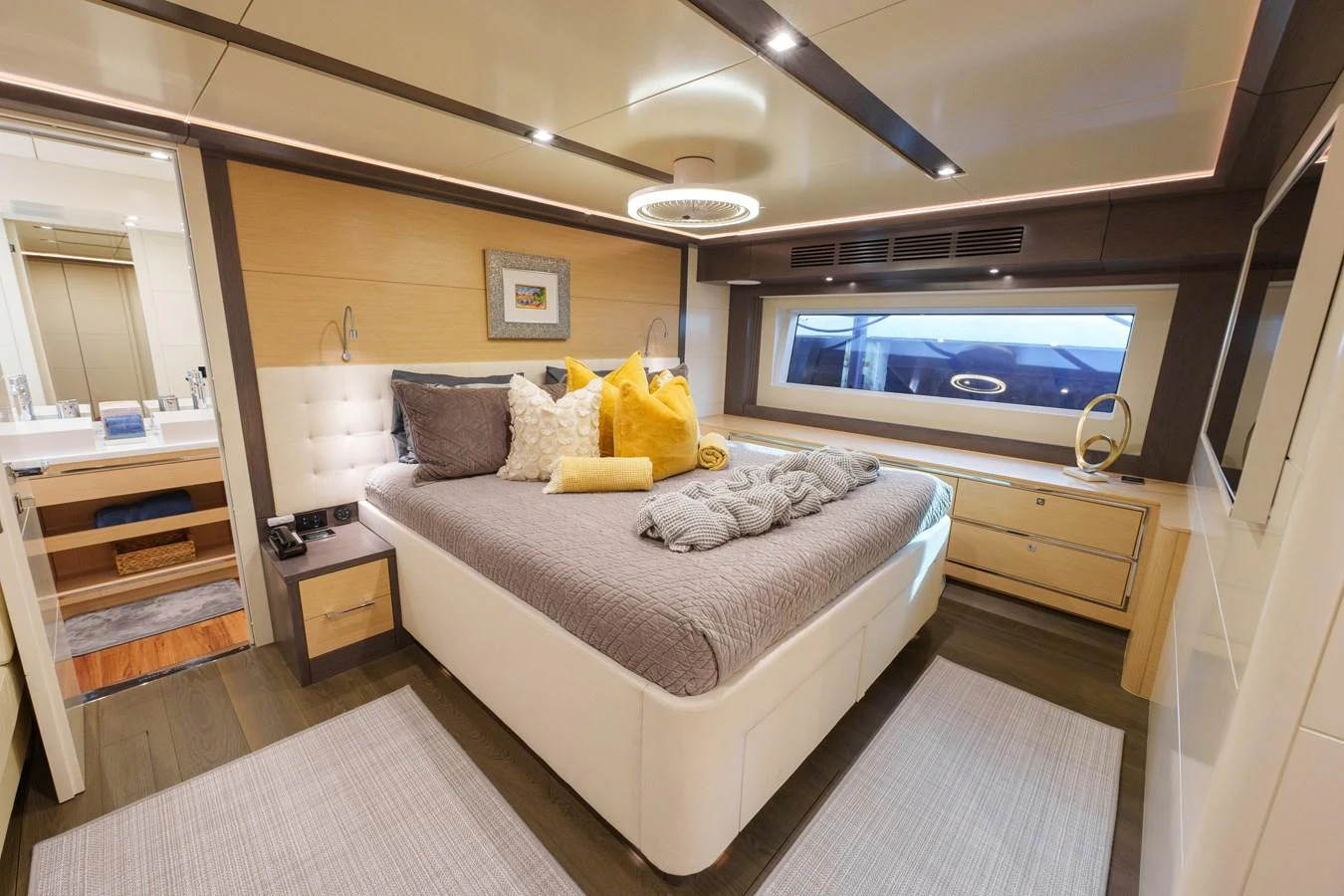 The stateroom features a luxurious bed with plush pillows and modern decor, providing a serene retreat. aboard FANTASEA Yacht for Sale