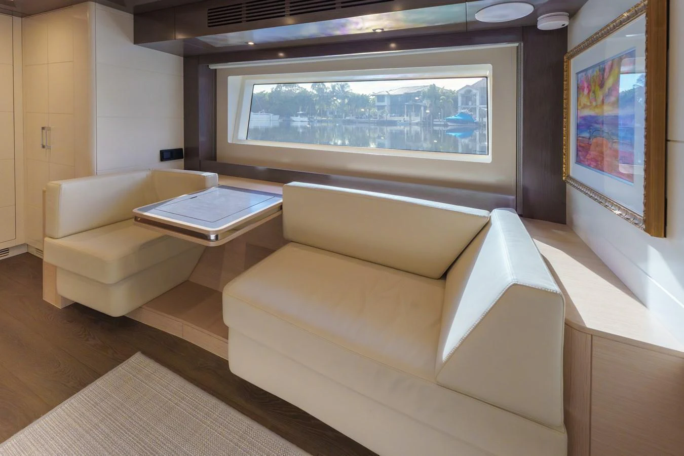 The salon features a cozy seating area with a large window offering scenic views. aboard FANTASEA Yacht for Sale