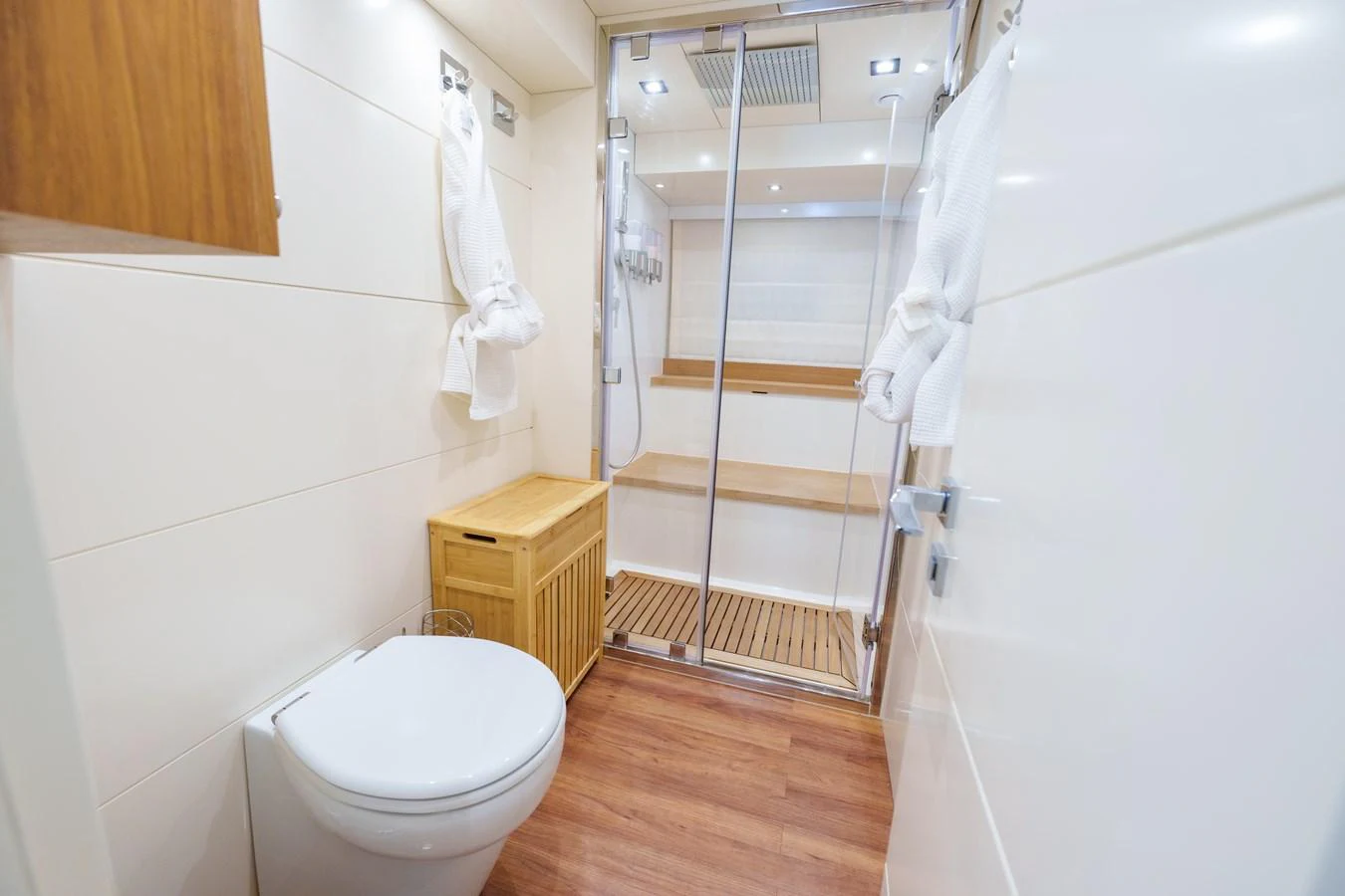 The yacht's bathroom features a modern design with a spacious shower and elegant wooden accents. aboard FANTASEA Yacht for Sale