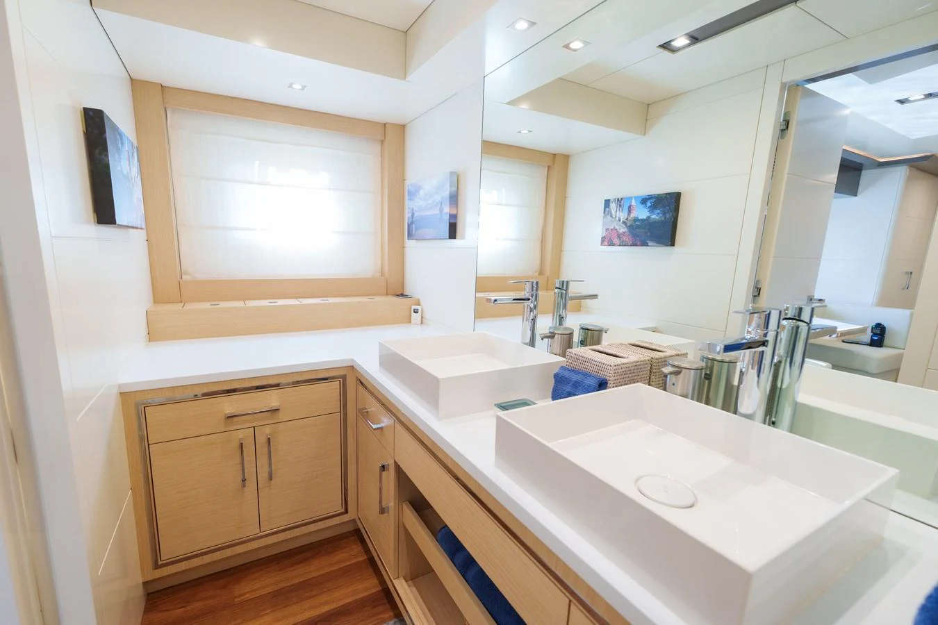 A modern and well-lit bathroom with sleek fixtures and ample counter space. aboard FANTASEA Yacht for Sale
