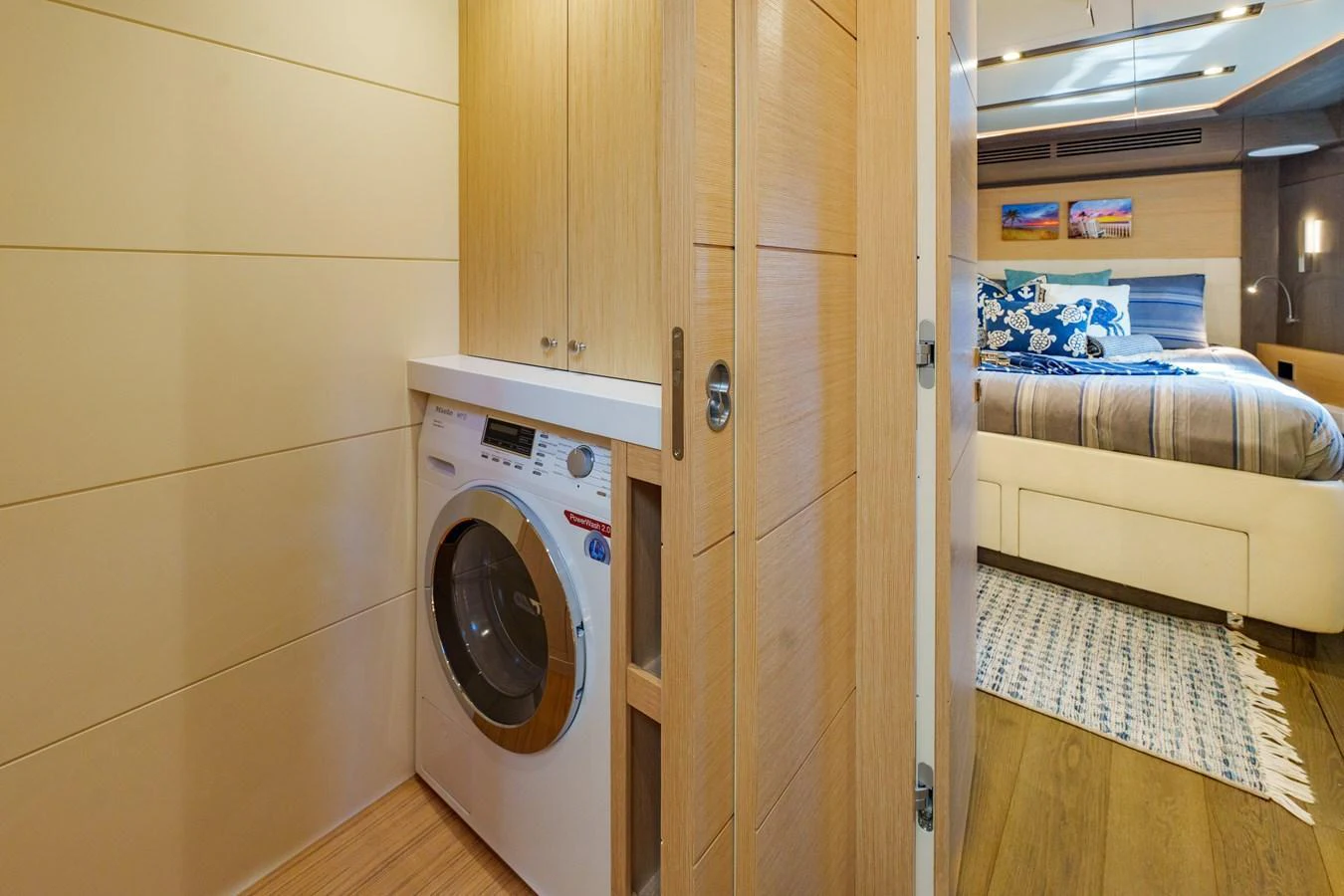 The yacht features a compact and efficient laundry area adjacent to a cozy stateroom. aboard FANTASEA Yacht for Sale
