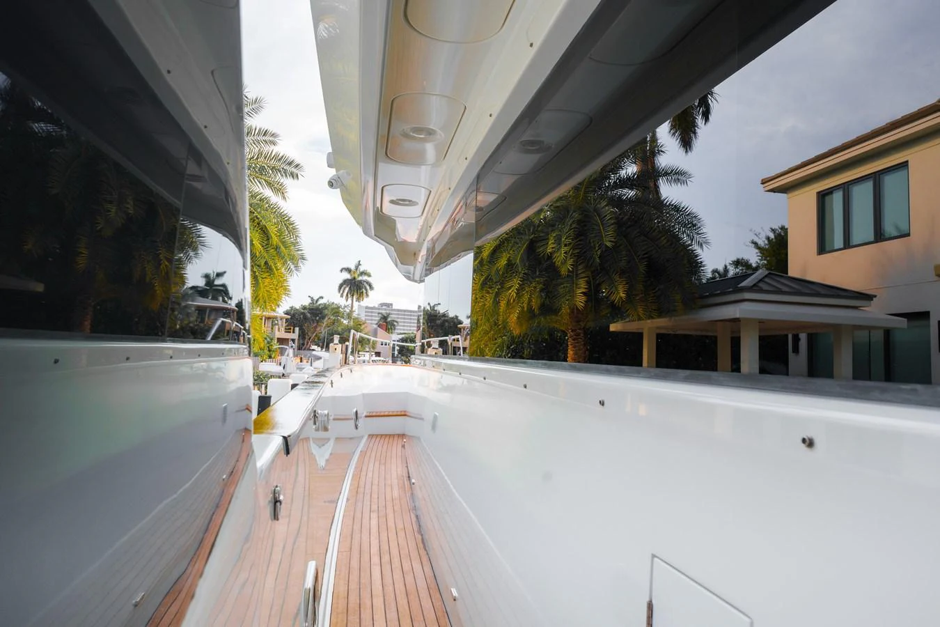 The image showcases the sleek side deck of a yacht, highlighting its polished surfaces and wooden flooring. aboard FANTASEA Yacht for Sale