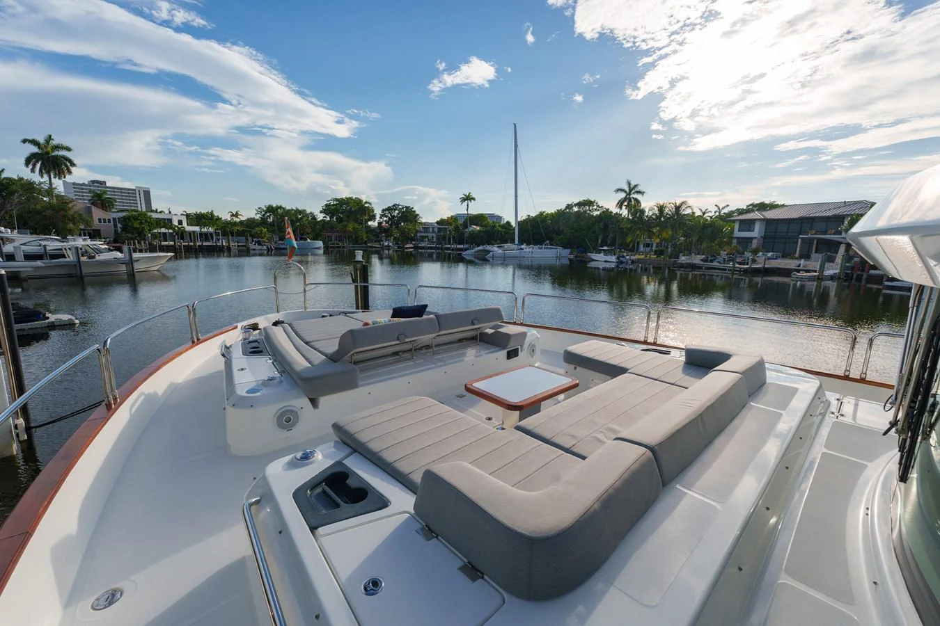 The yacht's aft deck features a spacious lounging area with plush seating and a central table, perfect for relaxation and socializing. aboard FANTASEA Yacht for Sale
