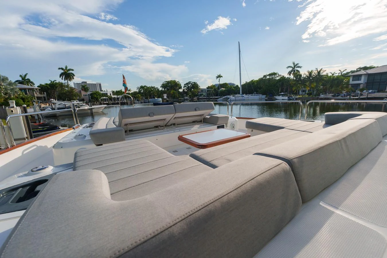 The aft deck offers a spacious and comfortable lounging area with a scenic view of the marina. aboard FANTASEA Yacht for Sale
