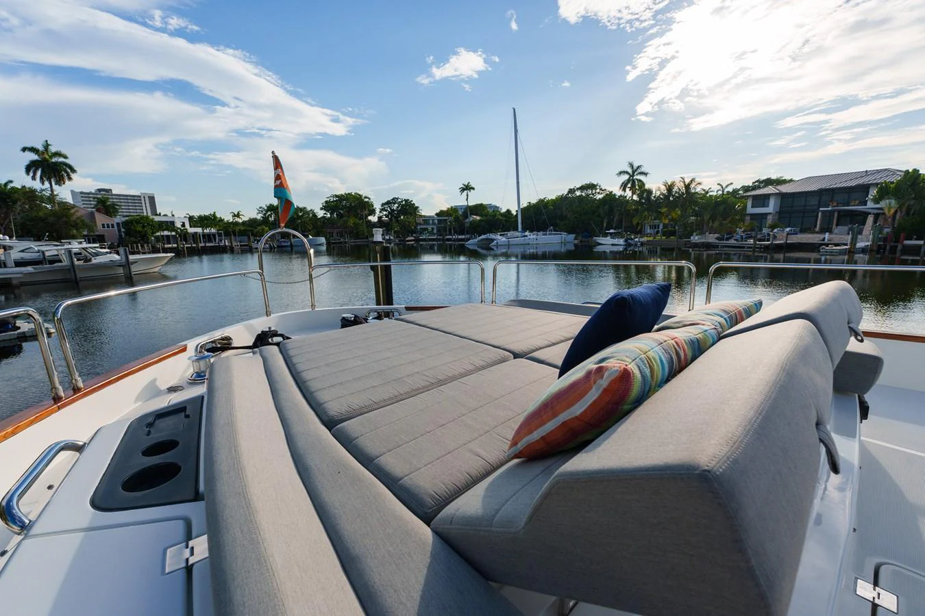 The sundeck features a spacious lounging area with comfortable cushions and vibrant pillows, perfect for relaxation. aboard FANTASEA Yacht for Sale