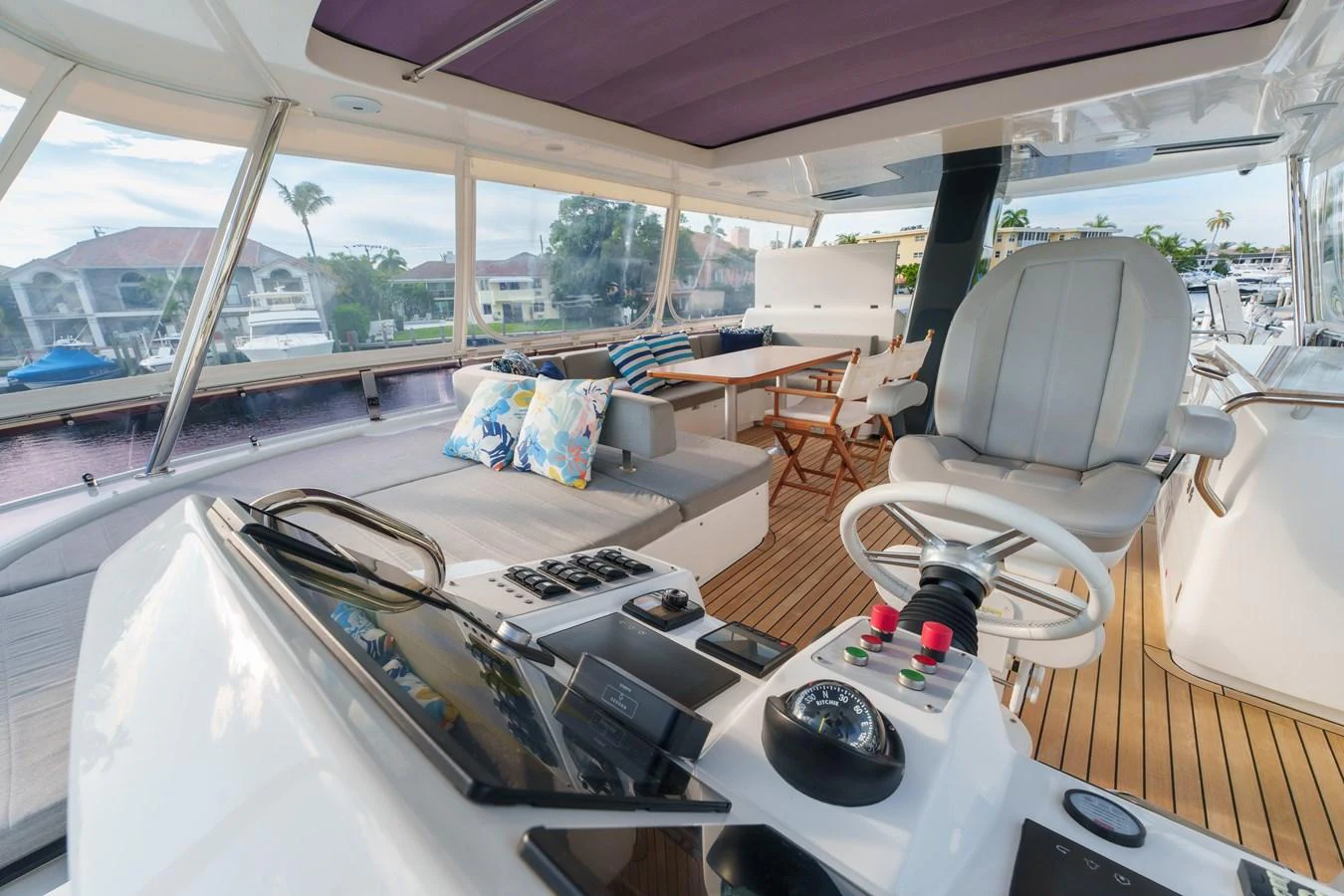 The helm area features a comfortable captain's chair, modern controls, and a spacious seating area with plush cushions. aboard FANTASEA Yacht for Sale