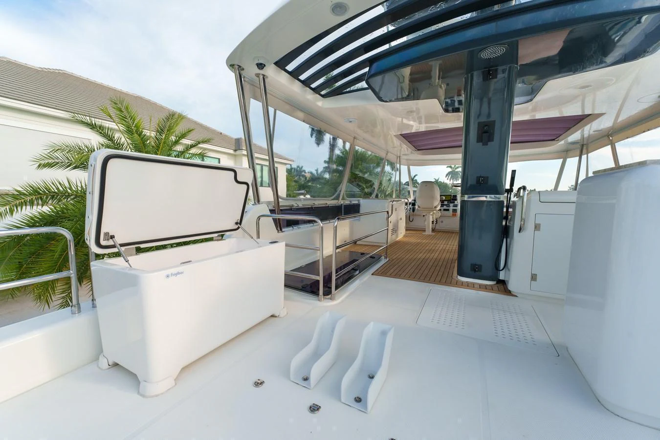 The aft deck features a spacious and functional layout with a cooler and seating area, perfect for outdoor relaxation. aboard FANTASEA Yacht for Sale