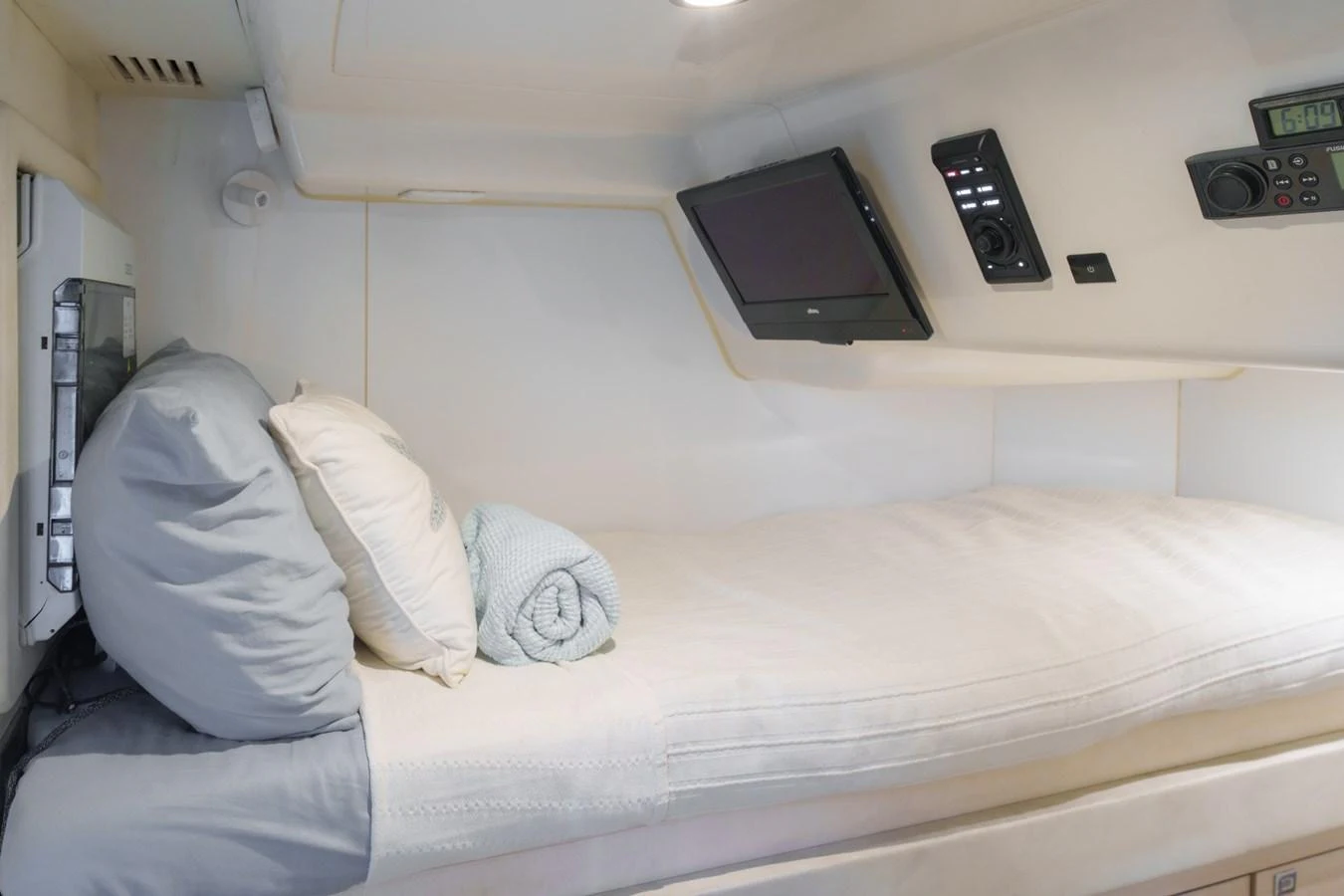 The crew cabin features a cozy single bed with modern amenities and a compact design. aboard FANTASEA Yacht for Sale