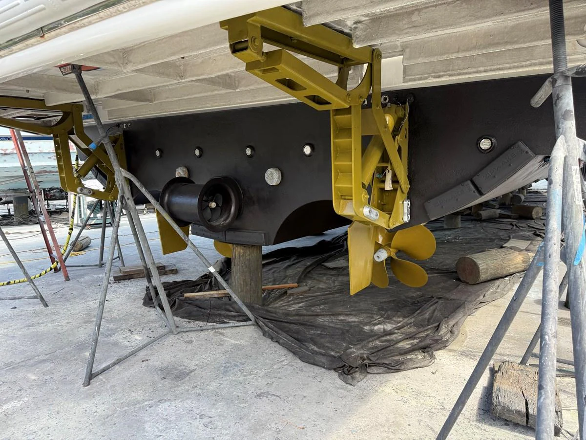 The image shows the underside of a yacht, highlighting the propeller and other mechanical components during maintenance. aboard FANTASEA Yacht for Sale