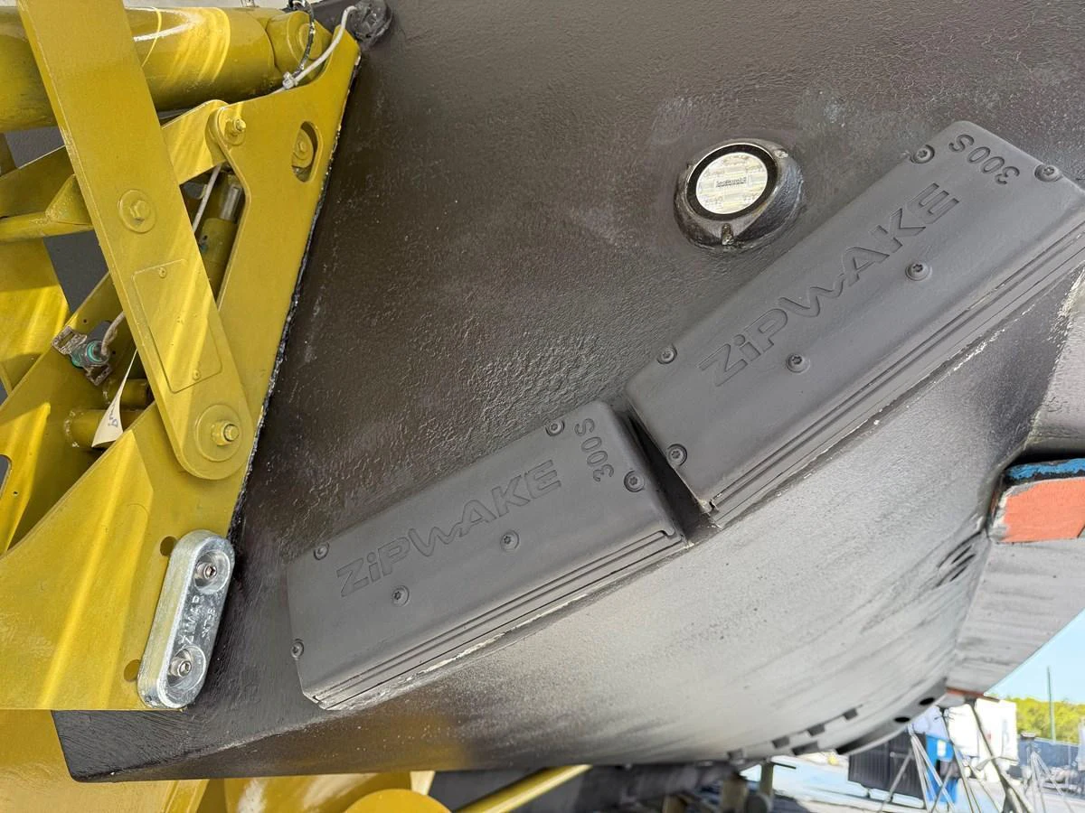 Close-up of the yacht's hull featuring Zipwake interceptors and mechanical components. aboard FANTASEA Yacht for Sale